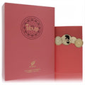 Luxurious Afnan Tribute Pink 3.4 oz EDP. Elegant ribbed rose-pink bottle with ornate gold accents and matching box.