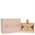 Aigner Icon 3.4 oz Eau de Parfum for women. Luxurious bottle with a distinctive gold metallic overlay, amber liquid, and elegant pink box.