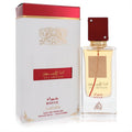 Lattafa Ana Abiyedh Rouge 2 oz unisex EDP. Elegant clear bottle with rich red cap, gold accents, and matching white & red box.