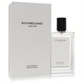 Richard James Aqua Aromatica Blade of Grass cologne. Elegant clear glass bottle with black cap and subtle green detail, beside its white box.