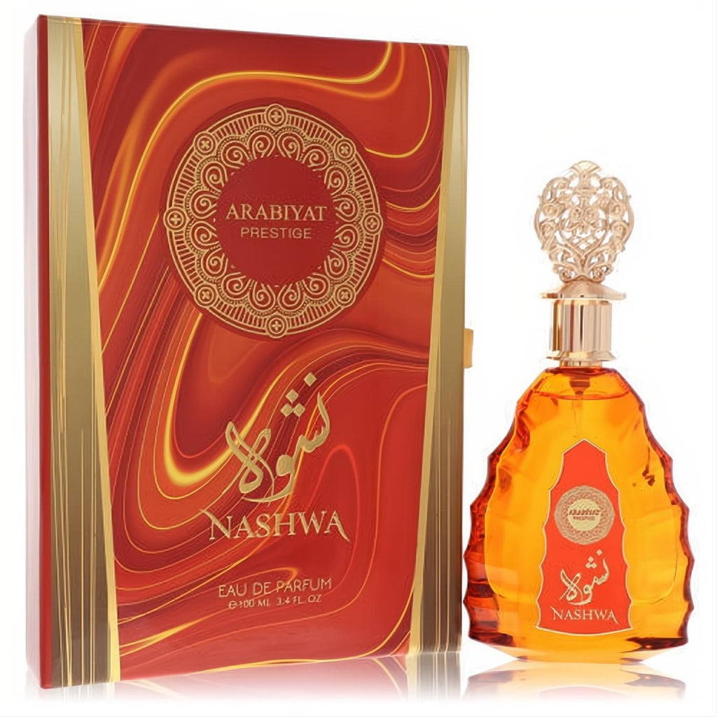 Arabiyat Prestige Nashwa 3.4 oz EDP. Amber fragrance in a distinctive bottle with ornate gold cap, beside a luxurious red and gold box.