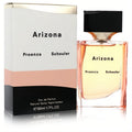 Elegant Arizona Proenza Schouler 1.7 oz EDP. Modern faceted glass bottle with warm amber liquid, sleek black cap, and stylish white, peach, black box.