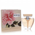 Elegant Armaf Momento Fleur 3.4 oz EDP spray. Clear V-shaped bottle with amber liquid, gold cap, and a beautiful pink peony box.