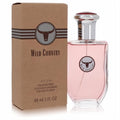 Avon Wild Country 3 oz men's cologne spray. Clear glass bottle with pink liquid, silver cap, and bull logo. Rustic brown box.