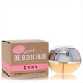 DKNY Be Extra Delicious 1.7 oz women's Eau De Parfum. Amber spherical glass bottle with metallic silver cap, next to its stylish brown and pink box.