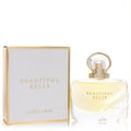 Luxurious Estee Lauder Beautiful Belle perfume: clear glass bottle with unique gold loop cap and matching white & gold box.
