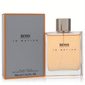 Boss In Motion by Hugo Boss 3.3 oz men's EDT. Sleek clear bottle with warm amber liquid, silver cap, and modern gray box with orange trim.
