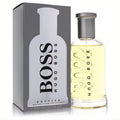 Hugo Boss No. 6 Bottled 6.7 oz EDT for men. Clear glass bottle with golden liquid, sleek grey cap, beside its iconic grey box.