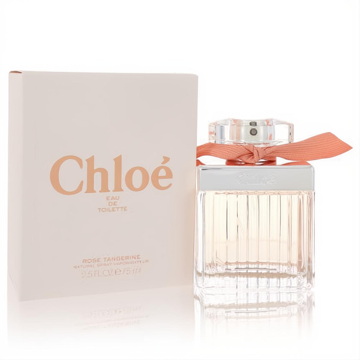 Chloé Rose Tangerine 2.5 oz Eau De Toilette. Elegant clear ribbed bottle with a chic peach ribbon, beside its matching soft pink box.