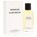 Elegant Keiko Mecheri Clair Obscur 3.4 oz Eau de Parfum. Clear glass bottle with golden liquid, sleek black cap, and white box.