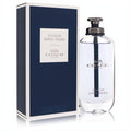 Coach Open Road men's 3.3 oz Eau de Toilette. Sleek clear glass bottle with dark cap and silver logo, next to its elegant dark blue box.