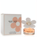 Charming Marc Jacobs Daisy Love 1.7 oz EDT spray with a clear bottle, peach liquid, and iconic white daisy cap with gold center, beside its floral box.