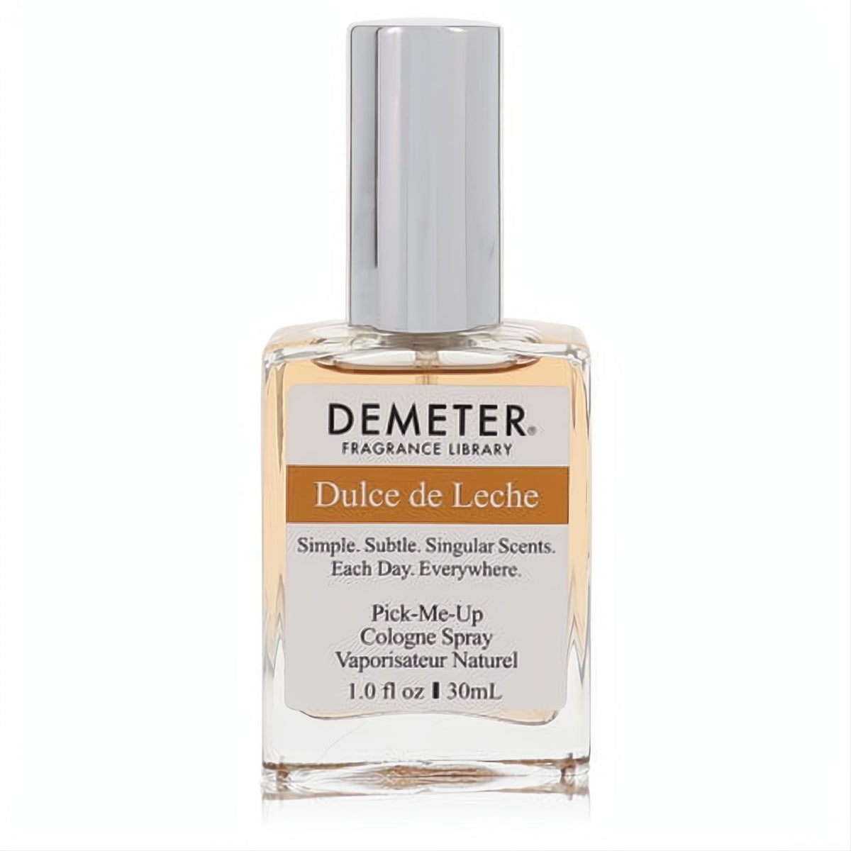Demeter Dulce De Leche 1 oz cologne spray. Clear rectangular glass bottle with a silver cap and warm caramel-colored liquid.