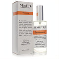 Demeter Persimmon 4 oz cologne spray in a sleek clear glass bottle with an orange label, next to its crisp white box.