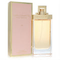 Elegant Diplomate Pour Femme 3.3 oz EDP in a sleek clear bottle with gold cap, next to its sophisticated rose gold box.