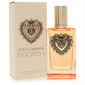 Dolce & Gabbana Devotion Intense EDP. Elegant clear bottle, warm amber liquid, and ornate gold heart with DG logo. Matching beige box.