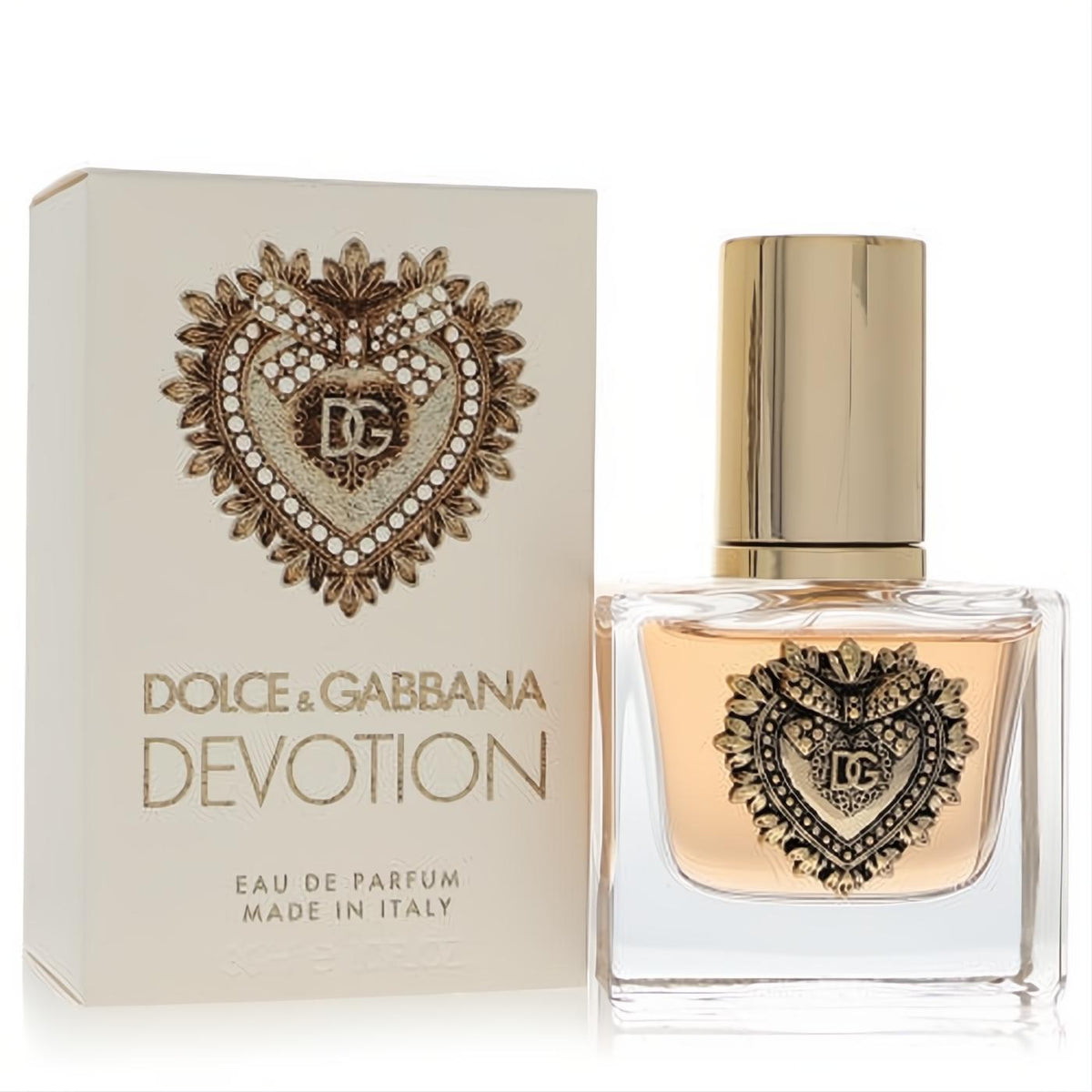 Luxurious Dolce & Gabbana Devotion 1 oz EDP spray. Clear bottle features iconic gold Sacred Heart design, beside its cream box.
