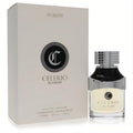Elegant Dumont Celerio Elysium 3.4 oz unisex EDP. Features a sleek cream box and a clear glass bottle with a silver cap and bold black accents.