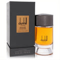 Luxurious Dunhill Moroccan Amber 3.4 oz EDP spray in a clear bottle with rich amber liquid and elegant black box.