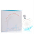 Captivating Hermes Eau des Merveilles Bleue 3.4 oz women's EDT. Features a round blue-tinted bottle with star design and elegant white box.