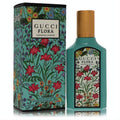 Gucci Flora Gorgeous Jasmine 1.6 oz EDP. Vibrant teal bottle with gold cap & matching box showcase elegant floral designs.