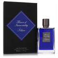 Experience Kilian Flower of Immortality 1.7 oz EDP. Luxurious deep blue glass bottle with sleek dark cap, next to its elegant black box.
