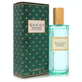 Gucci Memoire D'une Odeur 3.3 oz unisex EDP. Elegant ribbed teal glass bottle with gold cap and iconic dark green star box.