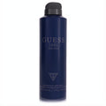 Guess 1981 Indigo men's fragrance body spray, 6 oz. Sleek dark blue can with bold branding and black cap.