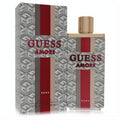 Guess Amore Roma unisex 3.4 oz EDT. Bold clear bottle with red, beige stripes, gold cap, and iconic G-patterned box.