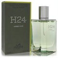 Hermes H24 Herbes Vives 1.7 oz EDP. Elegant refillable spray bottle with fresh green fragrance, silver cap, and matching matte olive box.
