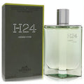 Hermes H24 Herbes Vives 3.4 oz refillable EDP. Sleek clear glass bottle with fresh green fragrance, silver cap, and matching olive box.