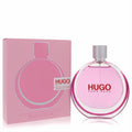 Hugo Extreme by Hugo Boss 2.5 oz women's EDP. Striking round pink glass bottle with silver cap, beside its sleek pink box.