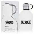 Hugo Reversed 4.2 oz men's EDT spray. Sleek white bottle with a silver cap, black strap, and matching minimalist box.