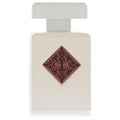 Initio Paragon 3.04 oz unisex fragrance: sleek white bottle with a distinctive reddish-brown diamond emblem and black scrollwork.