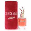 Jean Paul Gaultier So Scandal! 2.7 oz EDP. Daring clear bottle with peachy perfume, iconic gold leg cap, and vibrant red textured box.