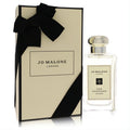 Jo Malone Fig & Lotus Flower 3.4 oz cologne spray. Clear glass bottle, silver cap, and elegant cream gift box with black ribbon.