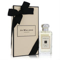 Sophisticated Jo Malone Pomegranate Noir cologne in a clear glass bottle with silver cap, beside its iconic cream gift box tied with a black ribbon.