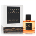 Joseph Abboud Bespoke 3.4 oz EDP. Amber fragrance in a clear glass bottle with black cap, next to its elegant white branded box.**