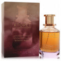 Luxurious Ktoret 173 Candy by Michael Malul 3.4 oz Eau De Parfum. Amber liquid in a clear bottle with gold cap, beside its gradient box.