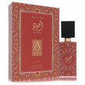 Captivating Lattafa Ajwad Pink to Pink 2 oz EDP. Ornate red/pink bottle with intricate gold Arabic script, sleek black cap, and matching patterned box.
