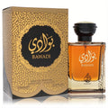 Lattafa Asdaaf Bawadi 3.4 oz EDP. Luxurious amber bottle with black and gold cap, displayed with its ornate gold and black patterned box.