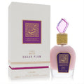 Lattafa Musk Sugar Plum 3.4 oz EDP. Luxurious pink bottle with a sparkling faceted purple cap, gold-wrapped neck, and elegant white box.