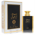 Lattafa Rouat Ajial 3.4 oz unisex EDP. Elegant black and gold bottle with a luxurious white and gold decorative presentation box.