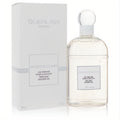 Guerlain Les Delices De Bain Perfumed Shower Gel, 6.7 oz. Clear glass bottle with elegant white cap and matching white box.