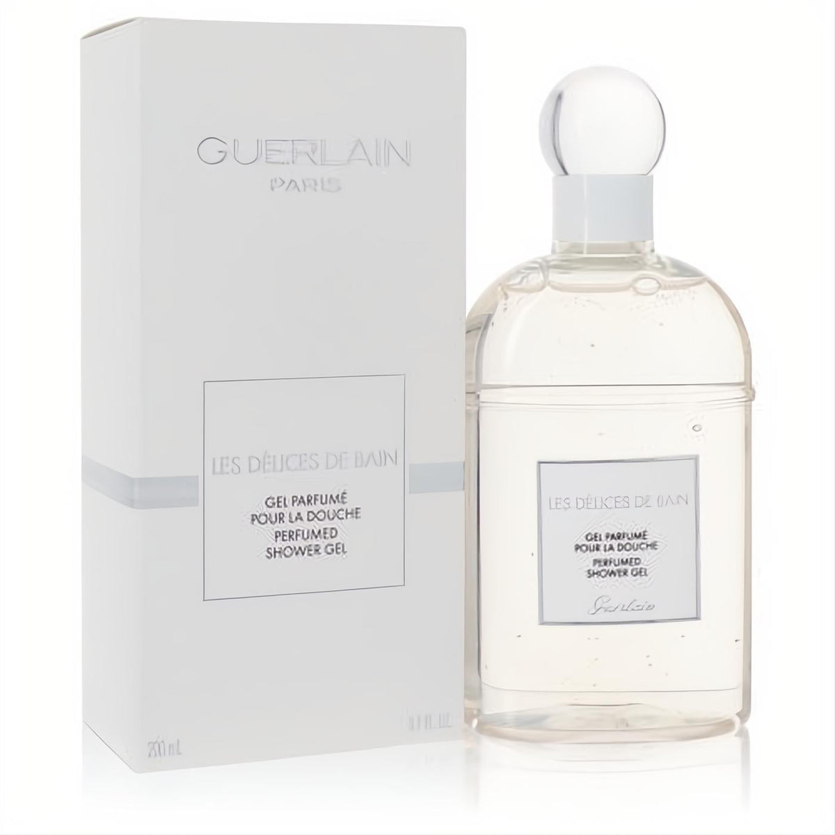 Guerlain Les Delices De Bain Perfumed Shower Gel, 6.7 oz. Clear glass bottle with elegant white cap and matching white box.