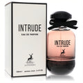 Maison Alhambra Intrude 3.4 oz EDP. Elegant pinkish-amber gradient glass bottle with black cap, ribbon, and white box.