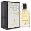 Luxurious Maison Alhambra Leonie 3.4 oz unisex EDP. Sleek clear bottle with gold 'LÉONIE' text and a sophisticated black box.