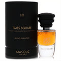 Masque Milano Times Square 1.18 oz unisex EDP. Distinctive amber & white bottle, black tiered cap, beside its matte black cylindrical box with gold text.