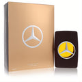 Elegant Mercedes Benz Private 3.4 oz Eau de Parfum. Dark brown bottle with silver logo reveals amber liquid, next to a luxurious golden box.