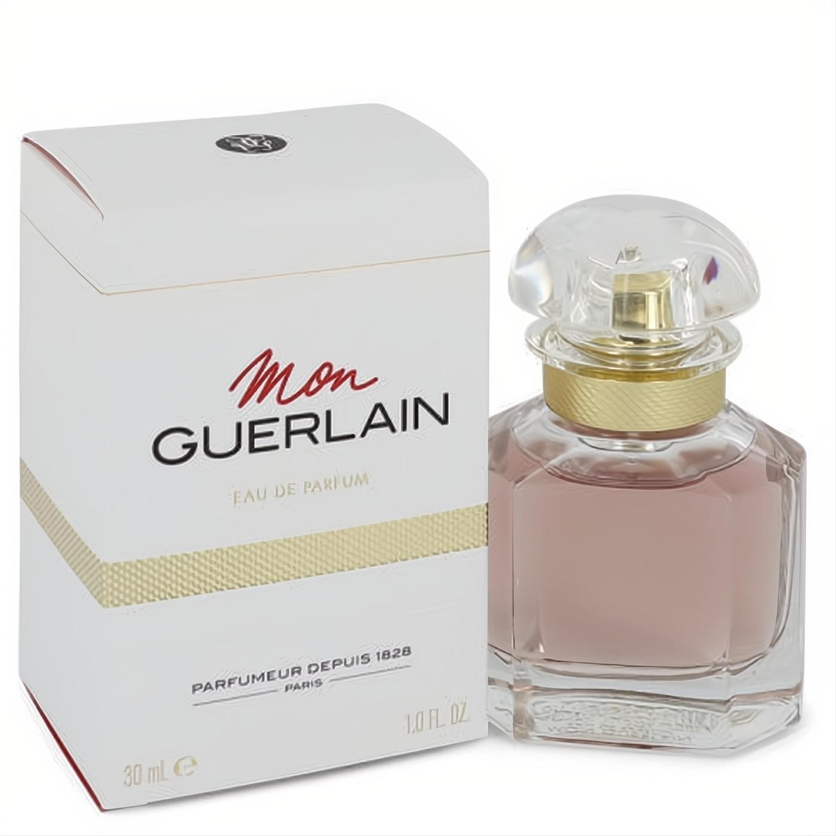 Mon Guerlain 1 oz Eau De Parfum. Elegant faceted glass bottle with light pink liquid, gold collar, and clear cap, beside its white and gold box.